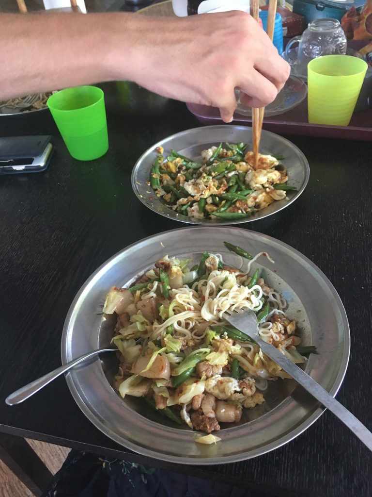 A photo of the food as described in the post. Leon is reaching in with chopsticks. 